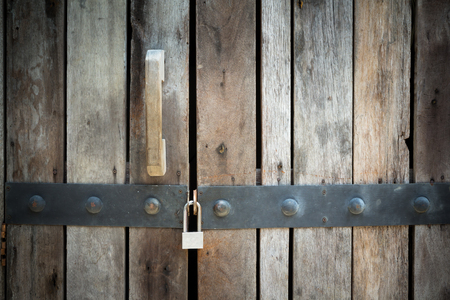 locked wooden door background with dark vignette, concept :  how to unlock potential, unlock your powerの写真素材