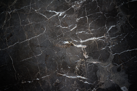 black stone background and texture with dark vignetteの写真素材