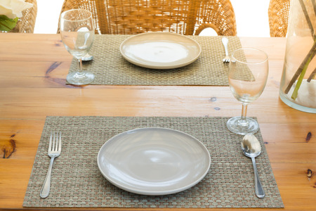 Casual table setting on wonden table near the beach, Dining table layout