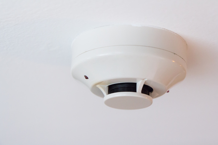 white smoke detector on ceilingの写真素材