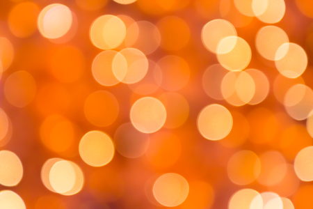blur orange bokeh background from the lights of chistmas treeの写真素材