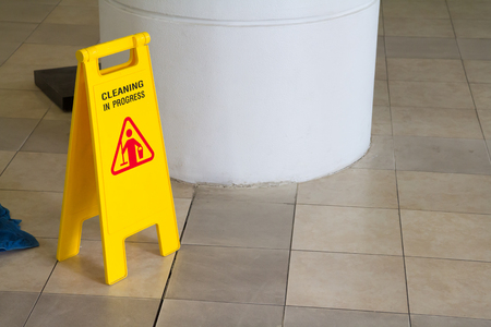 cleaning in progress sign, yellow plastic sign, warning wet floorの写真素材