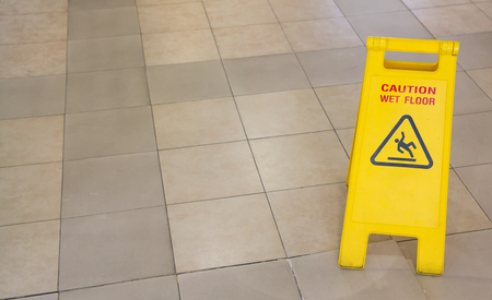 warning yellow plastic sign, caution wet floorの写真素材