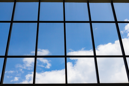blue sky and white cloud through silhouette window frameの写真素材