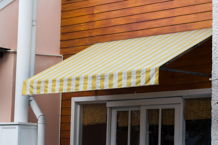 and white awning decor in front of the shopの写真素材