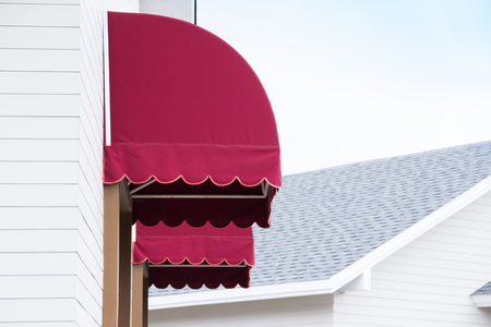 red canvas awnings of houseの写真素材