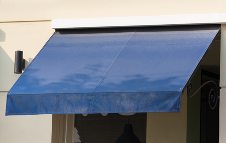 blue canvas awning over the shop windowの写真素材