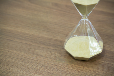 hourglass on wooden table free copyspace for textの写真素材