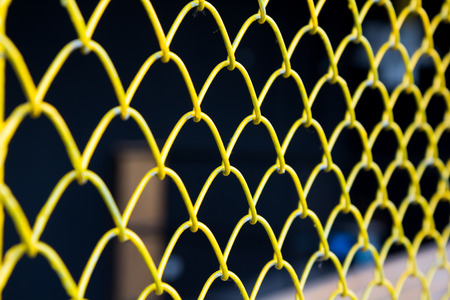 yellow wire grille isolate on black background, yellow metal wire meshの写真素材