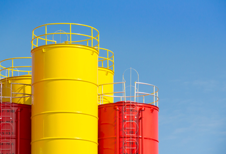 red and yellow steel silos. metal silos for concrete mix process plantの写真素材