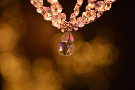 Vintage crystal necklace on black background with bokeh effect.の写真素材