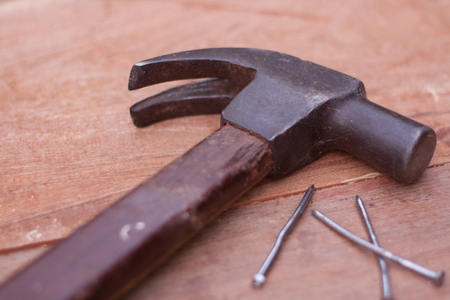 Hammer and nails on woodの写真素材