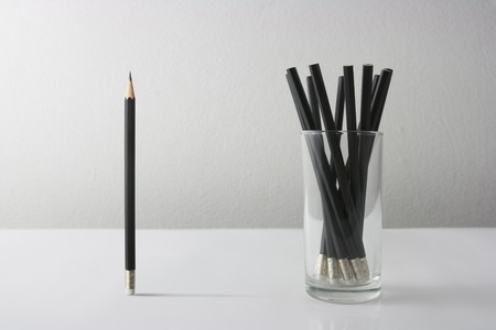 Individuality symbol and independent thinker concept and new leadership concept or individuality as a group of Pencil on white paper with one individual in the opposite direction as a business icon.の写真素材