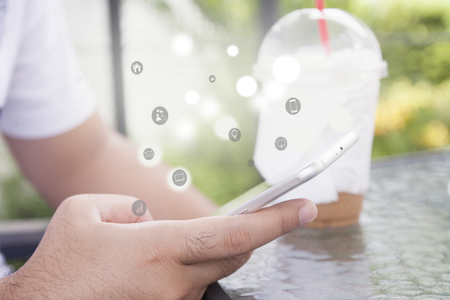 Close up of a man using mobile smart phone outdoor.Concept with social media communication.の写真素材