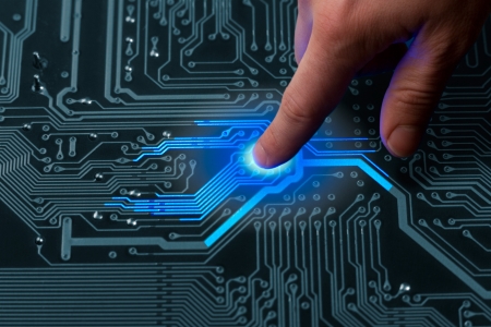 power mans finger is charging passive circuit board with blue energyの写真素材