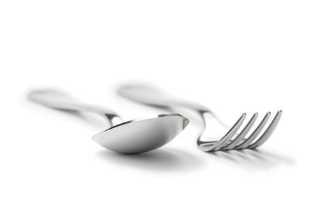 clean metallic fork and spoon isolated on white background with shadowsの写真素材