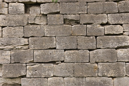 brown stone wall made from old sandstone bricksの写真素材