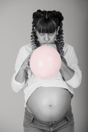 Beautiful pregnant woman with balloonの写真素材