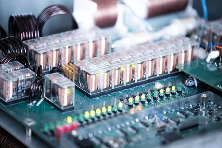 Close-up a large green microcircuit and luminous panels are found in a radio parts factory. Complex electronic equipment concept in a factoryの写真素材