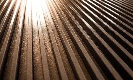 Close-up of a golden corrugated metal surface of unidentified equipment. The concept of sophisticated equipment and modern technology. The concept of manufacturing engineering devicesの写真素材