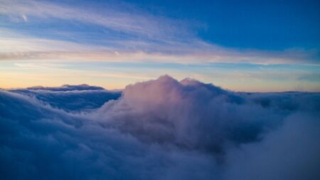 Magical view of blue cumulus clouds in winter at sunset. The concept of snow clouds and cold northern cyclones. Weather phenomenon concept. Copyspaceの写真素材