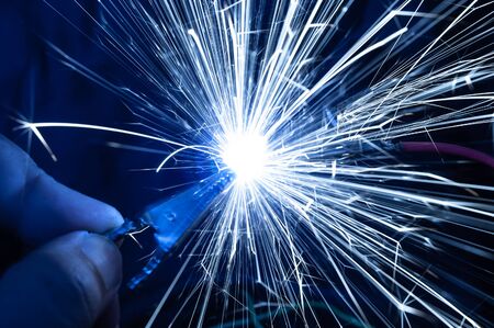 Bright burning sparks fly from incorrectly closed contacts. The concept of danger of electric shock and safety.の写真素材