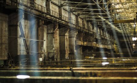 Industrial interior of old factory building, old rusty bathtub of acid.