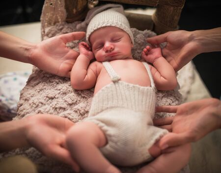 Portrait of a charming newborn little toddler in a knitted hat and shorts sleeping on a cozy bed. Cute of adorable kids concept. Childhood and naive conceptの写真素材