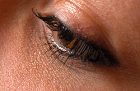 Close up blue eye with natural makeup looking at the side, macro shot with perfect skinの写真素材