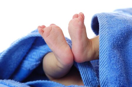 Four month old baby legs in blue towel