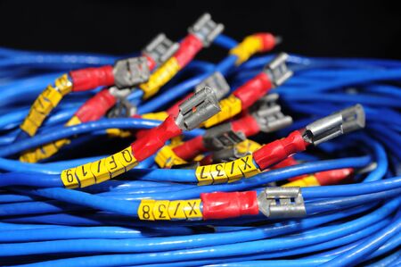 Close-up of a bundle of cut wires with metal connections sticking out of them. The concept of...