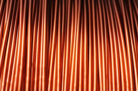 Close-up of a large coil of copper wire in the production of technical parts. Concept of electrical appliances and electricians. Advertising spaceの写真素材