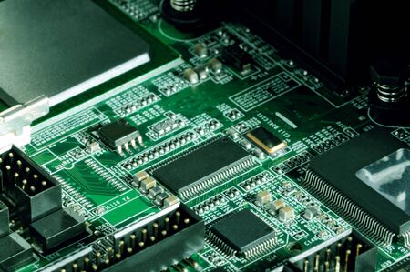 Close-up board with micro chips from an electrical appliance or computer. Concept of modern technology. Concept of electronics and microchipsの写真素材