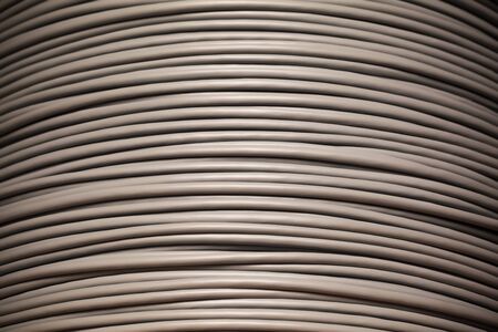 Close-up large skein with gray wire for Internet lines or electricity. Concept of connection and...