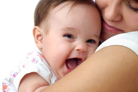Cheerful little baby smiling and joying on mothers shoulder. Togetherness loving mother and happy...