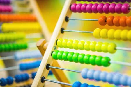 Children's wood abacus toy of bright color on the background of the playroom. Eco-friendly toysの写真素材