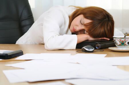 Adult attractive caucasian white brunette businesswoman sleeping or taking a nap at her laptop,...
