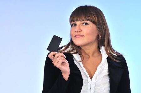 Successful caucasian white woman sale agent holding kard in hand. Portrait on light backgroundの写真素材