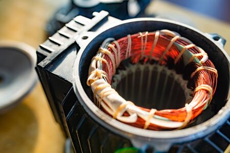 Close-up side view of a bundle of copper wire sticking out of unidentified plastic equipment in the manufacture of aircraft parts. Secret engineering equipment conceptの写真素材