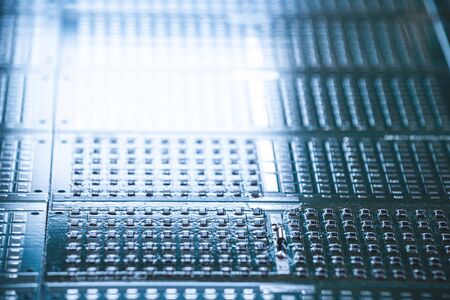 Close-up side view of a panel of indicator lights is located on the production of automatic control systems. The concept of industrial production of equipment for industrial and strategic purposesの写真素材