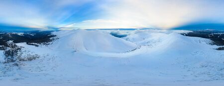 Magical panorama of a beautiful hill in the mountains covered by snow on the ski slope on a sunny day with a clear blue sky. Winter tourism concept. Copyspaceの写真素材