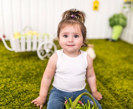 Portrait portrait of a cute little girl playing in her cozy kids room. The concept of healthy and...