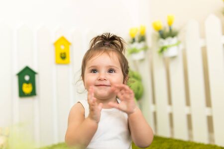 Portrait portrait of a cute little girl playing in her cozy kids room. The concept of healthy and...
