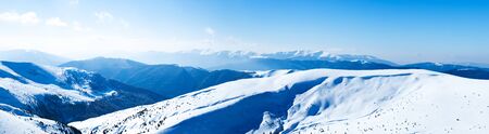 Panoramic view of mountains covered with snow on clear winter frosty day. View of winter wonderland nature conceptの写真素材