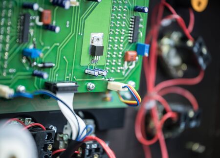 Assembled circuit of electrical relay inside metal case on steel frame with two inductance coils,...