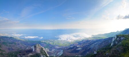 View of the huge rocky cliffs and green valley covered with forest. Beautiful mountain landscapeの写真素材
