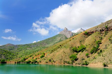 Beautiful summer landscape, lake with azure colored water located among the rocky mountainsの写真素材