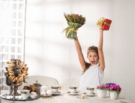Positive cute little girl holding New Year s giftの写真素材
