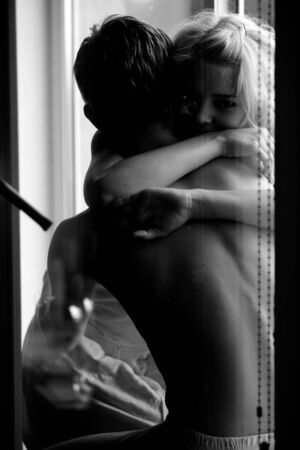 Young romantic happy caucasian couple man and woman hug and joyfully look at each other while...