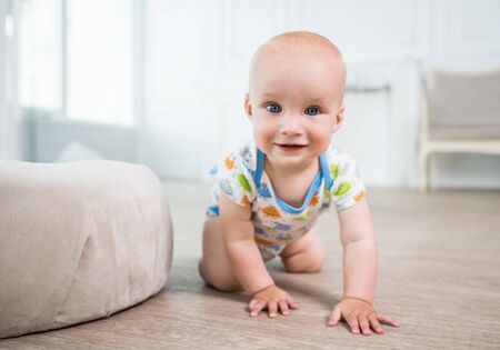Portrait of a little happy baby crawling